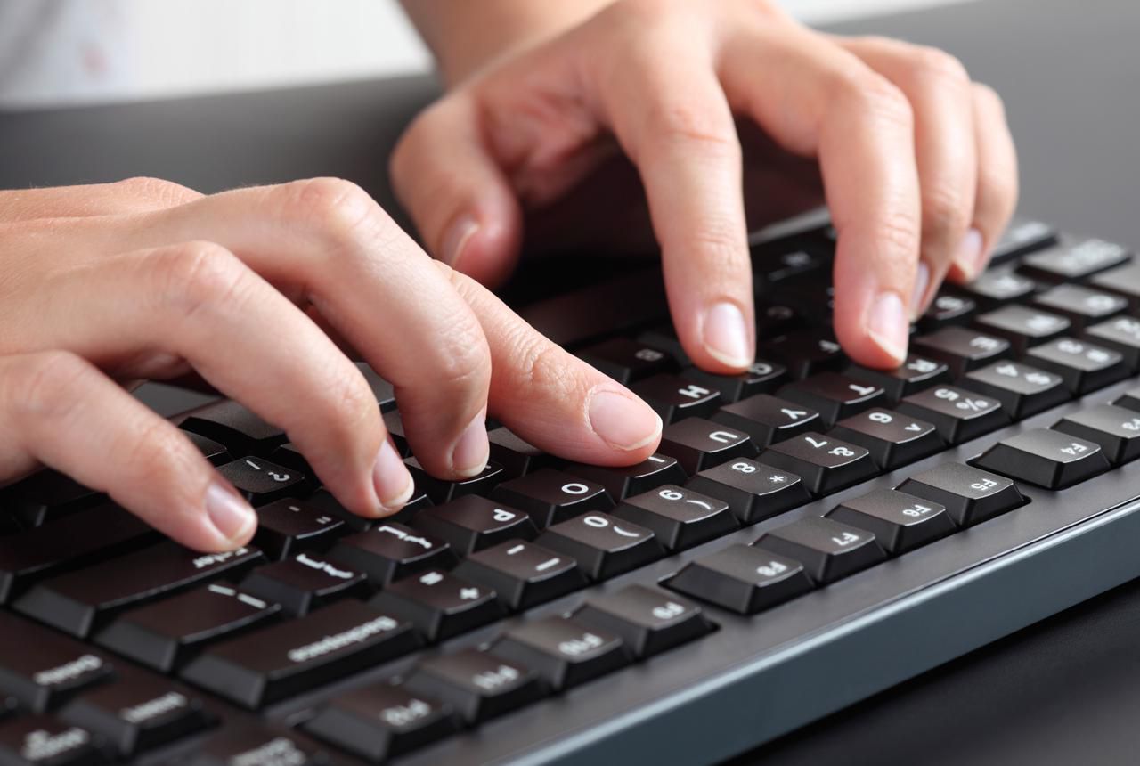 Picture of a woman typing on a keyboard